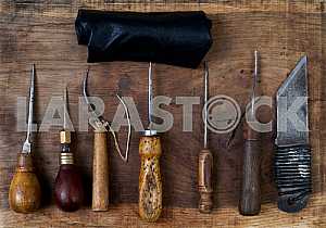 Different construction tools on a wooden background - screwdriver, caliper.