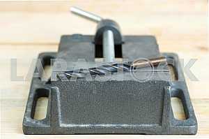 Different construction tools on a wooden background - screwdriver, caliper.