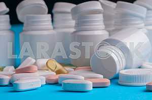 Many pills and tablets isolated on light blue background
