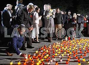 People light candles and lay flowers
