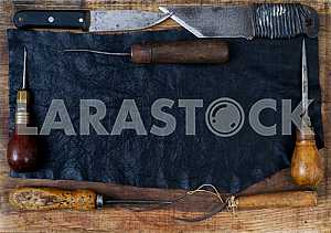 Different construction tools on a wooden background - screwdriver, caliper.