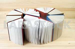 Stack of hardback books on wooden table. Back to school. Copy space