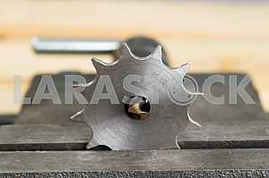 Different construction tools on a wooden background - screwdriver, caliper.