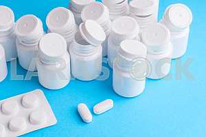 Many pills and tablets isolated on light blue background