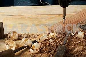 Carpenter tools on wooden table with sawdust. Circular Saw.