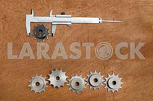 Different construction tools on a wooden background - screwdriver, caliper.