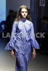 The model in blue dress demonstrates outfit by Ukrainian designer Maryana Steshenko
