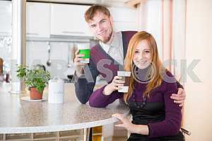 Young happy couple drinking tea in the morning