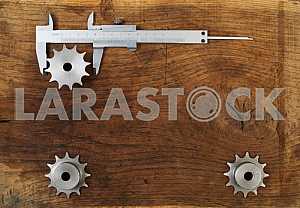 Different construction tools on a wooden background - screwdriver, caliper.