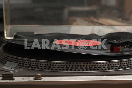 Retro styled image of a collection of old vinyl record lp's with sleeves on a wooden background. Copy space