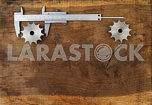 Different construction tools on a wooden background - screwdriver, caliper.