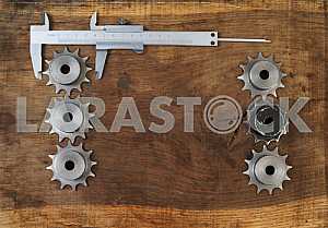 Different construction tools on a wooden background - screwdriver, caliper.