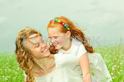 Mother and daughter with flower. Focus on eyes