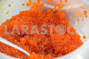 A bucket full of red caviar.