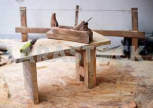 Different construction tools on a wooden background - screwdriver, caliper.