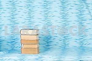 Old and used hardback books or text books on wooden table. Books and reading are essential for self improvement, gaining knowledge and success in our careers, business and personal lives. Copy space