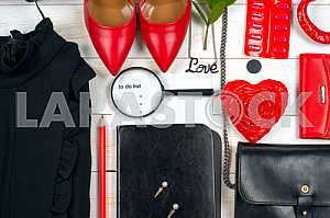 Women clothing set and accessories on white wooden background.