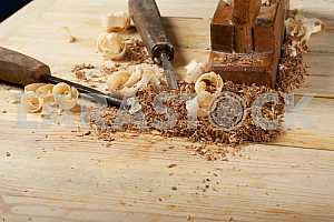 Carpenter tools on wooden table with sawdust. Circular Saw.