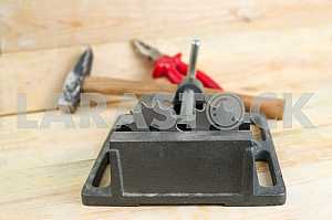Different construction tools on a wooden background - screwdriver, caliper.