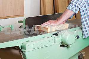 Carpenter tools on wooden table with sawdust. Circular Saw. Carpenter workplace top view