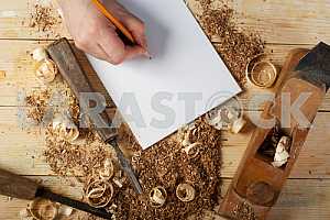 Carpenter tools on wooden table with sawdust. Circular Saw.