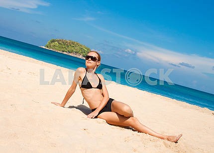 Happy young woman against azure sea