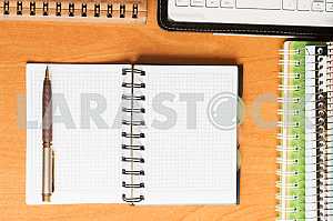 Stack of hardback books on wooden table. Back to school. Copy space. Top view