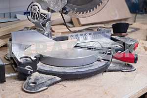 Different construction tools on a wooden background - screwdriver, caliper.