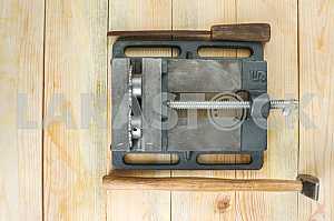 Different construction tools on a wooden background - screwdriver, caliper.