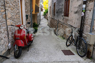 Scooter and bike on a narrow street in Skradin