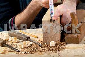 Carpenter tools on wooden table with sawdust. Circular Saw.