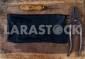 Different construction tools on a wooden background - screwdriver, caliper.