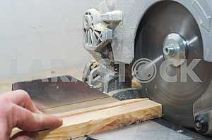 Carpenter tools on wooden table with sawdust. Circular Saw.