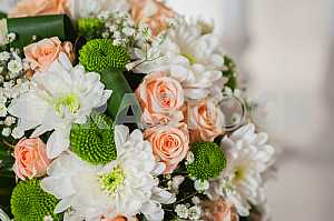 Wedding bouquet made of roses, chrysanthemum and laying on the white box