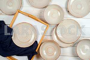 Blank white dish on a wood background.