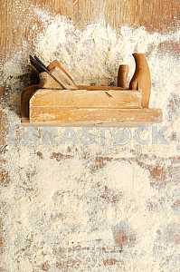 Different construction tools on a wooden background - screwdriver, caliper.