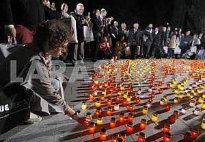 People light candles and lay flowers