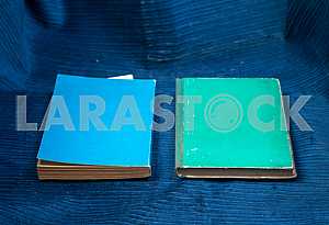 Open book, stack of hardback books on wooden table. Back to school. Copy space