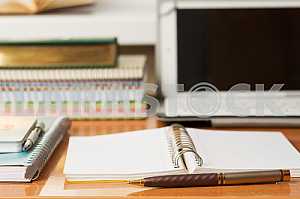 Stack of hardback books on wooden table. Back to school. Copy space. Top view