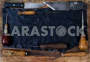 Different construction tools on a wooden background - screwdriver, caliper.