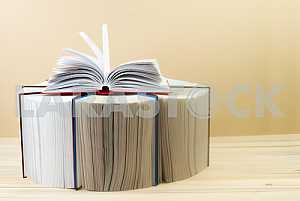 Stack of hardback books on wooden table. Back to school. Copy space