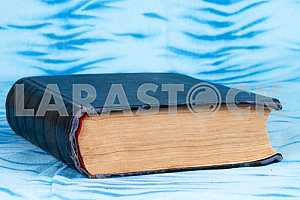 Old and used hardback books or text books on wooden table. Books and reading are essential for self improvement, gaining knowledge and success in our careers, business and personal lives. Copy space