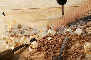 Carpenter tools on wooden table with sawdust. Circular Saw.