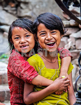 Two girls sincerely smile at the camera