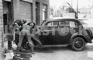 German soldiers repairing a car
