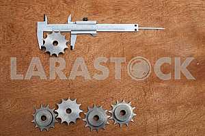 Different construction tools on a wooden background - screwdriver, caliper.