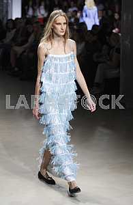 The model in blue dress demonstrates outfit by Ukrainian designer Maryana Steshenko