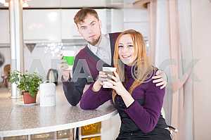 Young happy couple drinking tea in the morning