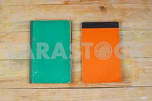 Open book, stack of hardback books on wooden table. Back to school. Copy space