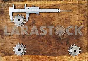 Different construction tools on a wooden background - screwdriver, caliper.